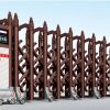 Cửa xếp tự động hợp kim nhôm JH-048 màu nâu đồng cổ điển, thiết kế chắc chắn cho cổng chính nhà máy, xí nghiệp.